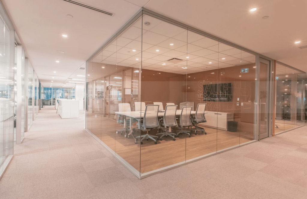 Large meeting room surrounded by integrated glass wall system